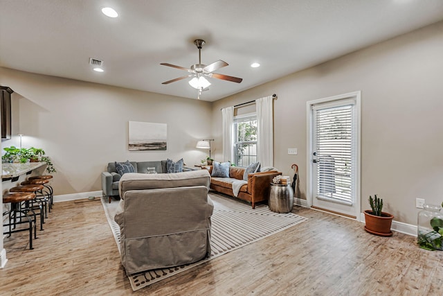 8726 Brown Pelican Cir, Navarre, FL 32566 - living room featuring baseboards, light wood-type flooring, ceiling fan, and recessed lighting