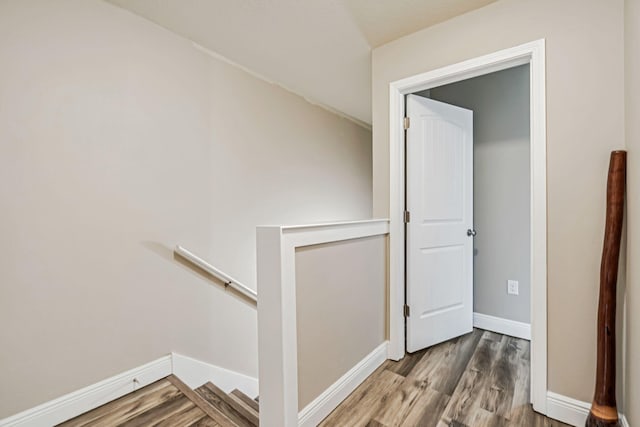 8726 Brown Pelican Cir, Navarre, FL 32566 - hall featuring an upstairs landing, wood finished floors, and baseboards