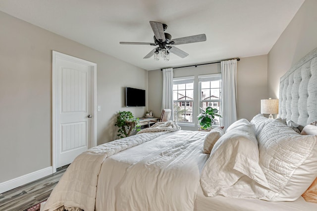 8726 Brown Pelican Cir, Navarre, FL 32566 - bedroom featuring wood finished floors, baseboards, and a ceiling fan