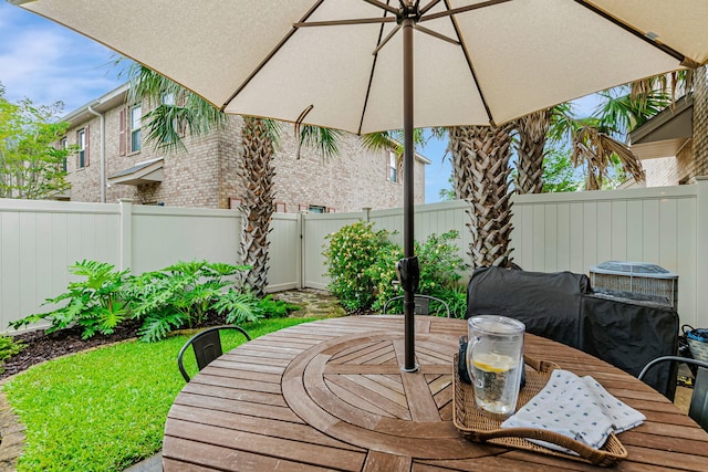 8726 Brown Pelican Cir, Navarre, FL 32566 - deck featuring outdoor dining area and a fenced backyard