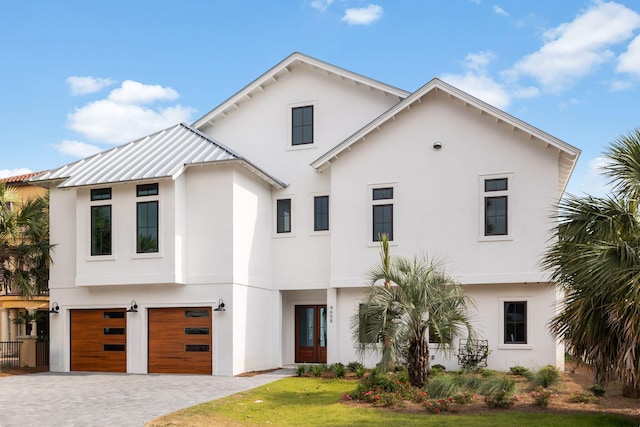 4658 Destiny Way, Destin, FL 32541 - view of front of house featuring stucco siding, a garage, driveway, french doors, and a standing seam roof