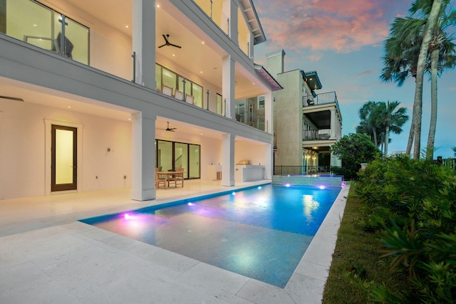 4658 Destiny Way, Destin, FL 32541 - pool at dusk featuring a ceiling fan, an outdoor pool, and a patio