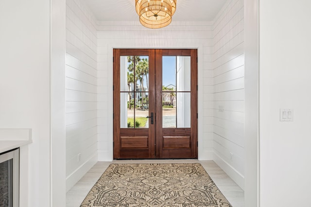 4658 Destiny Way, Destin, FL 32541 - doorway featuring french doors, a chandelier, light wood finished floors, wine cooler, and wood walls
