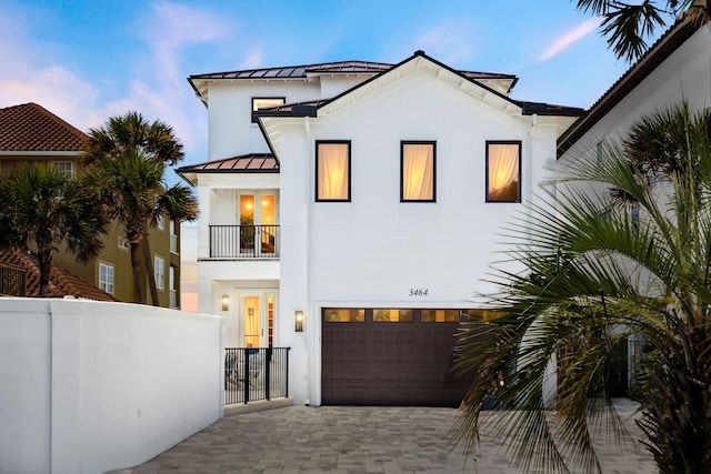 3464 Scenic Highway 98, Destin, FL 32541 - view of front of home featuring a balcony, a standing seam roof, decorative driveway, an attached garage, and stucco siding