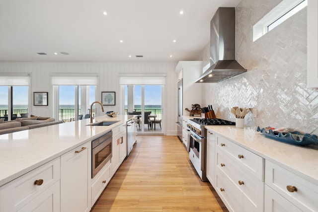 3464 Scenic Highway 98, Destin, FL 32541 - kitchen featuring high end appliances, island range hood, a sink, backsplash, and white cabinetry