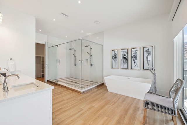 3464 Scenic Highway 98, Destin, FL 32541 - full bathroom featuring a stall shower, a freestanding bath, wood finished floors, double vanity, and recessed lighting