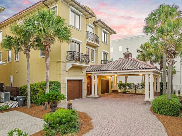 17 Saint Martin Cir, Miramar Beach, FL 32550 - view of front facade featuring a balcony, driveway, central AC, a tile roof, and a gazebo