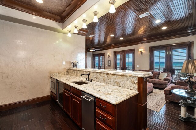 17 Saint Martin Cir, Miramar Beach, FL 32550 - kitchen featuring ornamental molding, a peninsula, dark wood-type flooring, a sink, and baseboards