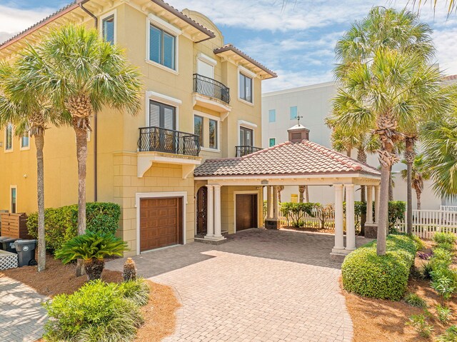 17 Saint Martin Cir, Miramar Beach, FL 32550 - mediterranean / spanish-style house featuring driveway, a tiled roof, a garage, and a balcony