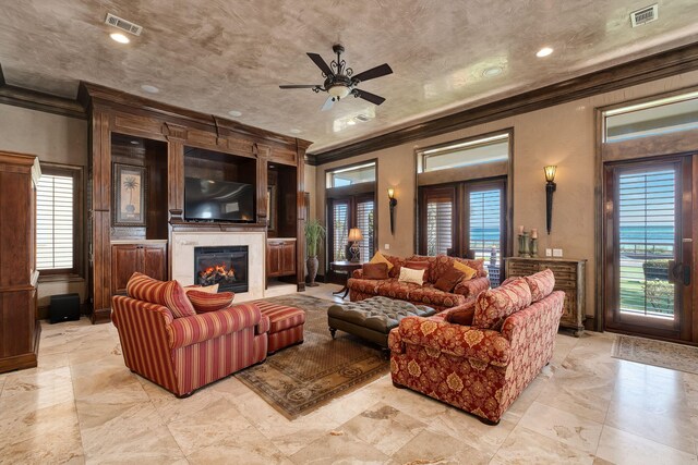 17 Saint Martin Cir, Miramar Beach, FL 32550 - living area with crown molding, healthy amount of natural light, a ceiling fan, and a glass covered fireplace