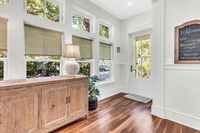 18 Eastern Lake Ct, Santa Rosa Beach, FL 32459 - entryway with dark wood-style floors, wainscoting, and a decorative wall