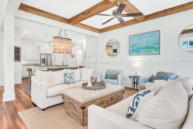 18 Eastern Lake Ct, Santa Rosa Beach, FL 32459 - living area featuring a ceiling fan, beamed ceiling, wood finished floors, a decorative wall, and coffered ceiling