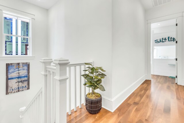 18 Eastern Lake Ct, Santa Rosa Beach, FL 32459 - hall with an upstairs landing, wood finished floors, and baseboards