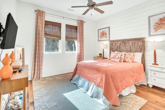 18 Eastern Lake Ct, Santa Rosa Beach, FL 32459 - bedroom featuring wood finished floors, wood walls, and ceiling fan