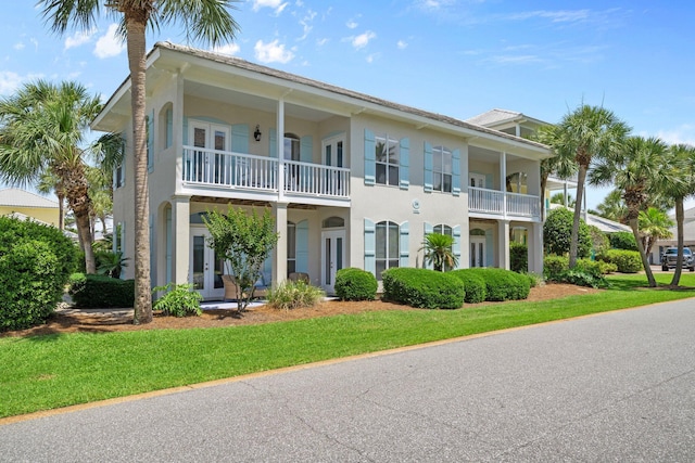 34 Opal Cv, Miramar Beach, FL 32550 - view of front of house featuring french doors, stucco siding, and a front lawn