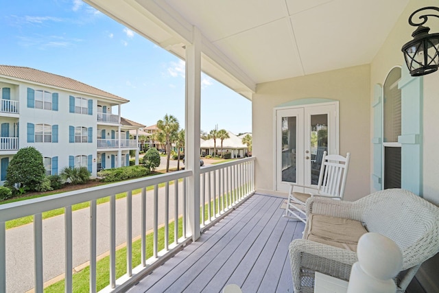 34 Opal Cv, Miramar Beach, FL 32550 - wooden terrace with french doors and a residential view