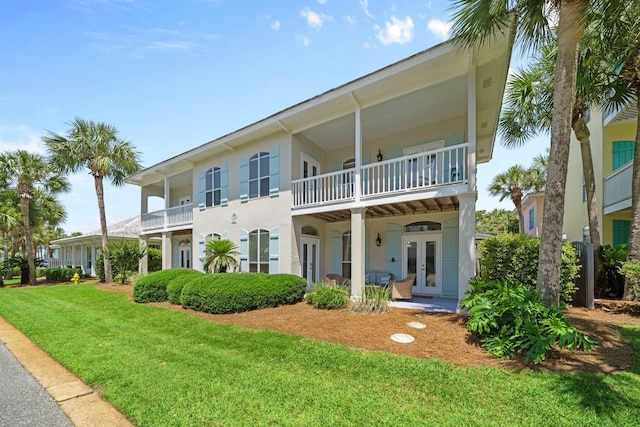 34 Opal Cv, Miramar Beach, FL 32550 - rear view of house with french doors, a yard, stucco siding, and a balcony