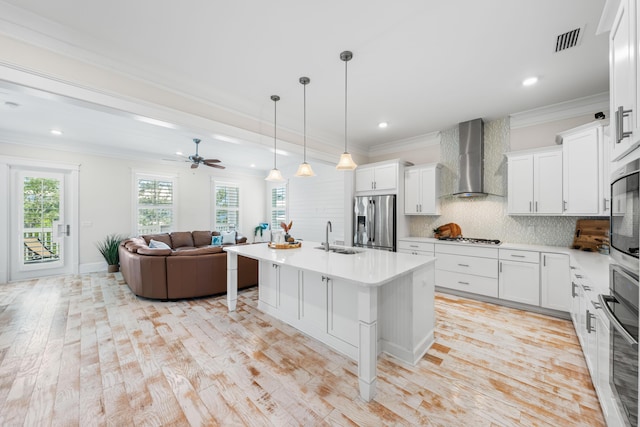 164 Clipper St, Inlet Beach, FL 32461 - kitchen featuring stainless steel appliances, wall chimney range hood, crown molding, open floor plan, and a sink