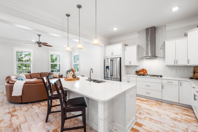 164 Clipper St, Inlet Beach, FL 32461 - kitchen with appliances with stainless steel finishes, wall chimney exhaust hood, a sink, ornamental molding, and light wood-type flooring