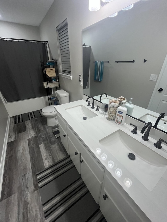 8945 Bluebell St, Milton, FL 32583 - full bathroom featuring toilet, wood finished floors, and double vanity