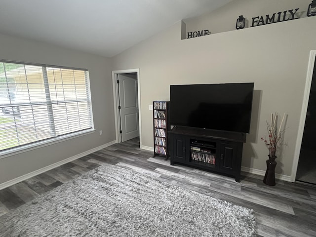 8945 Bluebell St, Milton, FL 32583 - unfurnished living room with lofted ceiling, wood finished floors, and baseboards
