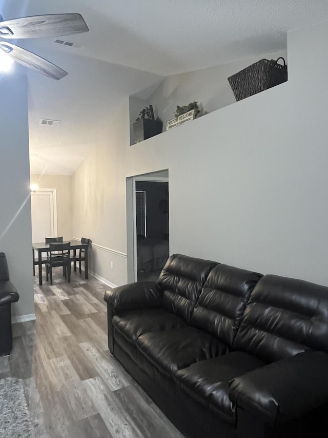 8945 Bluebell St, Milton, FL 32583 - living area with wood finished floors, lofted ceiling, and baseboards
