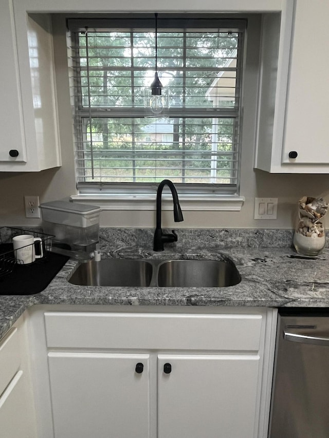 8945 Bluebell St, Milton, FL 32583 - kitchen featuring a sink, white cabinets, and stainless steel dishwasher