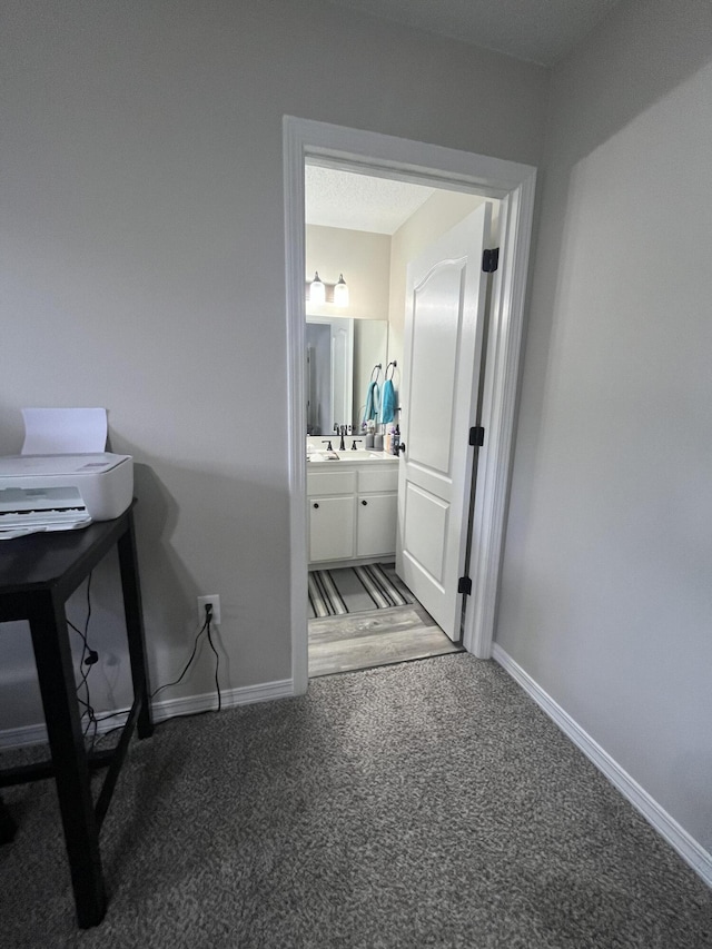 8945 Bluebell St, Milton, FL 32583 - hall with carpet floors, baseboards, and a sink