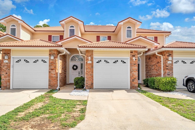 526 Valparaiso Pkwy Unit B, Valparaiso, FL 32580 - view of property featuring a tiled roof, concrete driveway, and an attached garage