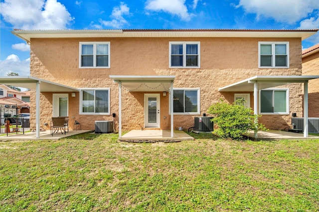 526 Valparaiso Pkwy Unit B, Valparaiso, FL 32580 - rear view of house with central AC unit, a patio, stucco siding, and a yard
