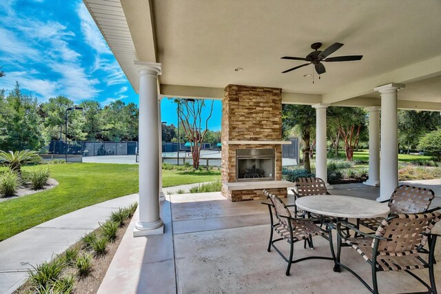 302 Sand Myrtle Trl, Destin, FL 32541 - view of patio / terrace with an outdoor stone fireplace, a ceiling fan, and outdoor dining area