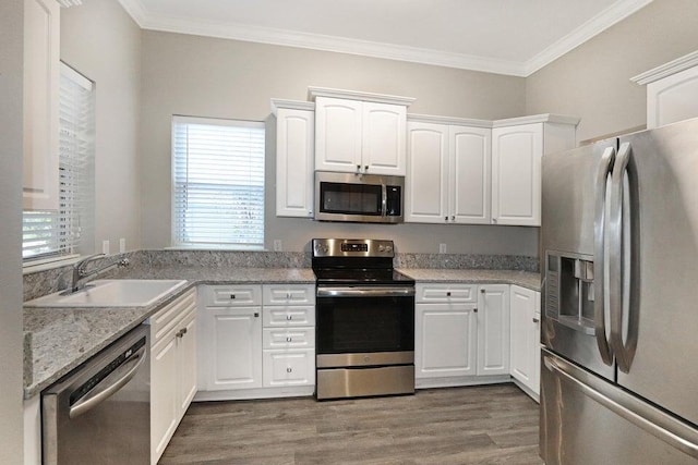 302 Sand Myrtle Trl, Destin, FL 32541 - kitchen featuring stainless steel appliances, dark wood finished floors, white cabinets, ornamental molding, and light stone counters
