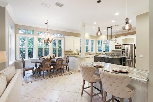 302 Sand Myrtle Trl, Destin, FL 32541 - kitchen featuring appliances with stainless steel finishes, ornamental molding, a kitchen island, light tile patterned flooring, and healthy amount of natural light