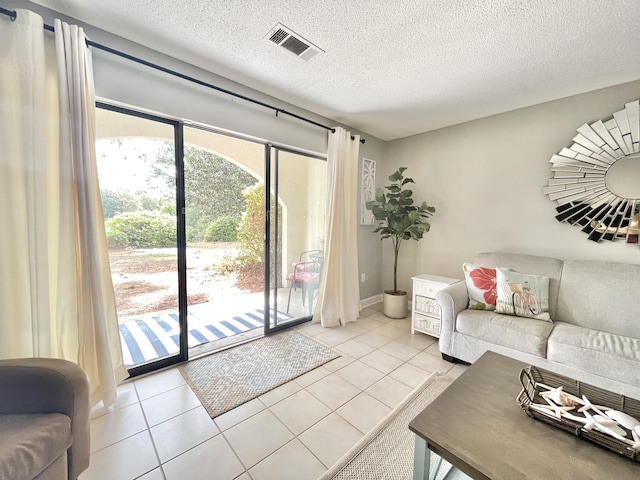 305 Southlake Ct Unit 305, Niceville, FL 32578 - living room with light tile patterned floors and a textured ceiling