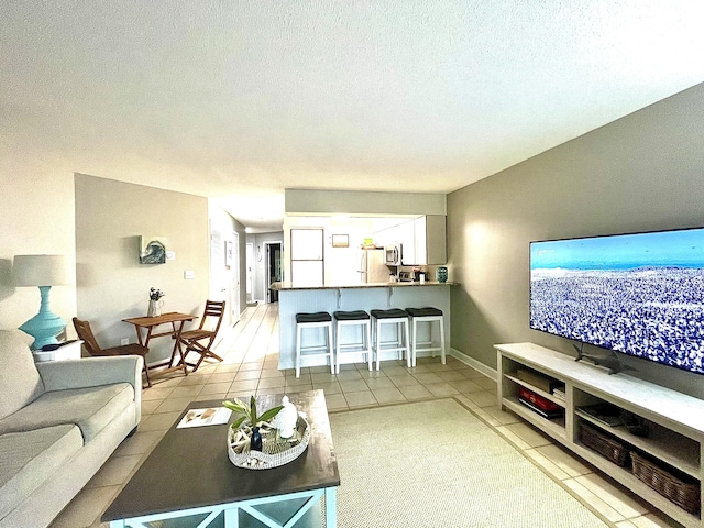 305 Southlake Ct Unit 305, Niceville, FL 32578 - living area featuring light tile patterned floors and a textured ceiling