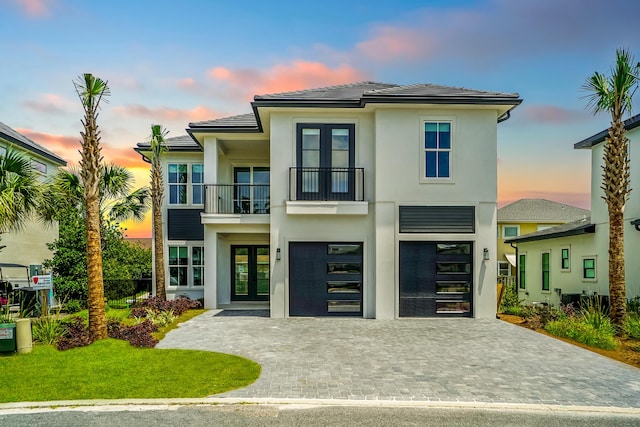 127 Avalon Blvd, Miramar Beach, FL 32550 - view of front facade featuring french doors, a balcony, decorative driveway, and stucco siding