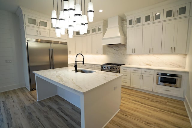 127 Avalon Blvd, Miramar Beach, FL 32550 - kitchen featuring premium range hood, a sink, high end appliances, a chandelier, and light wood finished floors