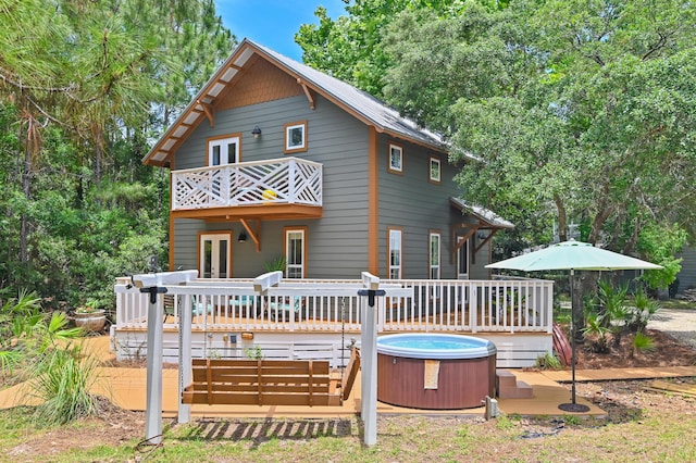 69 Austinwood Ln, Santa Rosa Beach, FL 32459 - back of house featuring a hot tub, a balcony, french doors, and a wooden deck