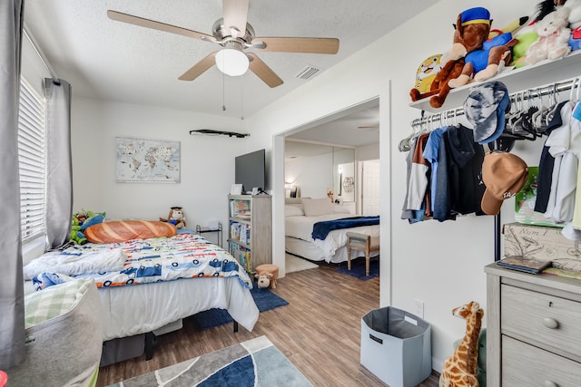 16 Court Dr, Destin, FL 32541 - bedroom with wood finished floors, ceiling fan, and a textured ceiling