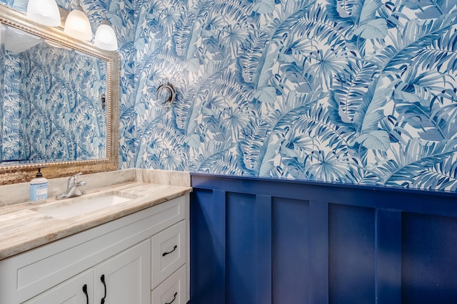 16 Court Dr, Destin, FL 32541 - bathroom with wallpapered walls, vanity, a wainscoted wall, and a decorative wall