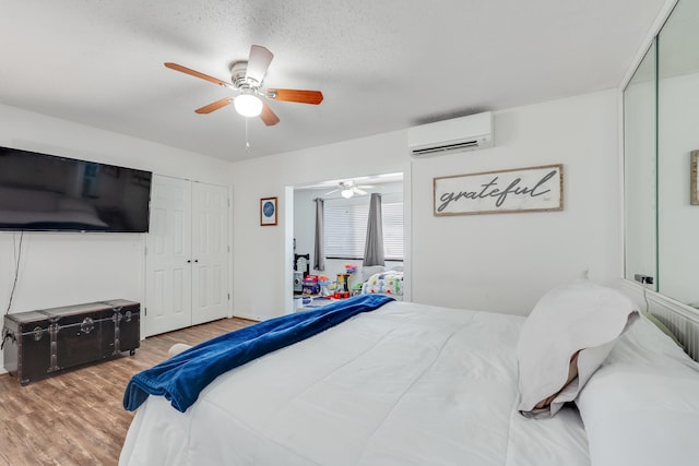 16 Court Dr, Destin, FL 32541 - bedroom featuring a wall unit AC, wood finished floors, and a ceiling fan