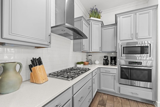11 E Pine Lands Loop Unit A, Inlet Beach, FL 32461 - kitchen with stainless steel appliances, exhaust hood, gray cabinets, ornamental molding, and light countertops