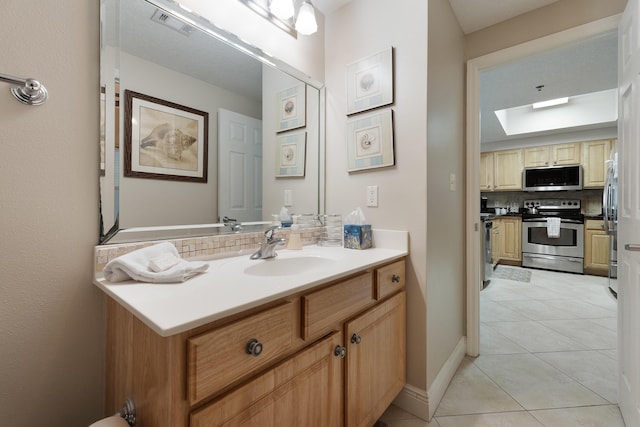 112 Seascape Dr Unit 1807, Miramar Beach, FL 32550 - bathroom featuring tasteful backsplash, vanity, tile patterned floors, and a skylight
