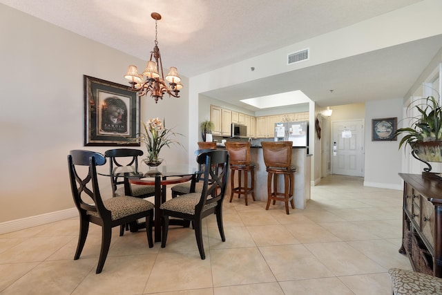 112 Seascape Dr Unit 1807, Miramar Beach, FL 32550 - dining room featuring a chandelier, light tile patterned flooring, and baseboards