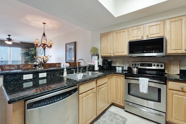 112 Seascape Dr Unit 1807, Miramar Beach, FL 32550 - kitchen with appliances with stainless steel finishes, a sink, light brown cabinetry, a peninsula, and backsplash