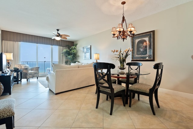 112 Seascape Dr Unit 1807, Miramar Beach, FL 32550 - dining room with a chandelier, a ceiling fan, light tile patterned flooring, and baseboards