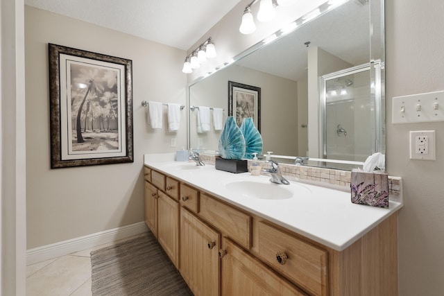 112 Seascape Dr Unit 1807, Miramar Beach, FL 32550 - bathroom with double vanity, a shower with shower door, tile patterned floors, and baseboards
