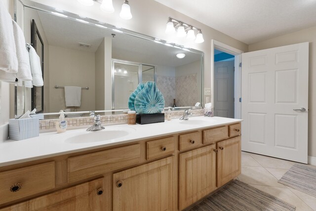 112 Seascape Dr Unit 1807, Miramar Beach, FL 32550 - full bathroom featuring double vanity, a stall shower, and tile patterned floors