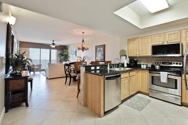 112 Seascape Dr Unit 1807, Miramar Beach, FL 32550 - kitchen featuring stainless steel appliances, light brown cabinets, a sink, a peninsula, and light tile patterned floors