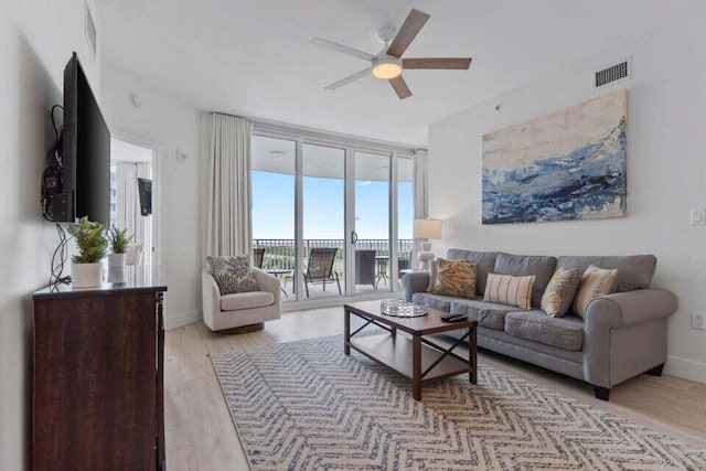 4207 Indian Bayou Trl Unit 2815, Destin, FL 32541 - living room featuring a ceiling fan, light wood-style flooring, and baseboards